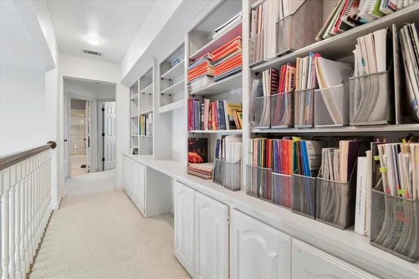 a view of a workspace with furniture and a window