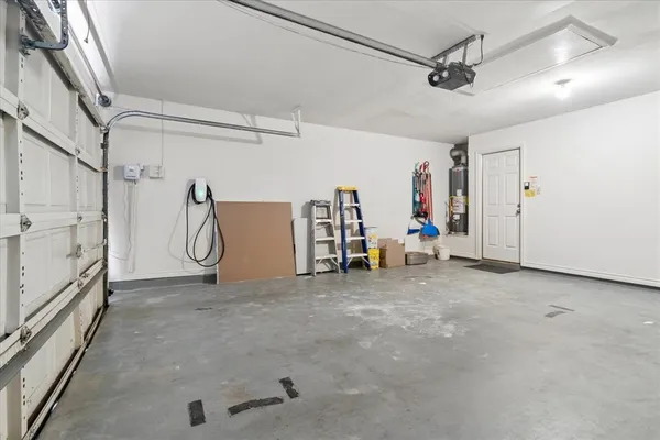 a view of backyard with potted plants and wooden fence