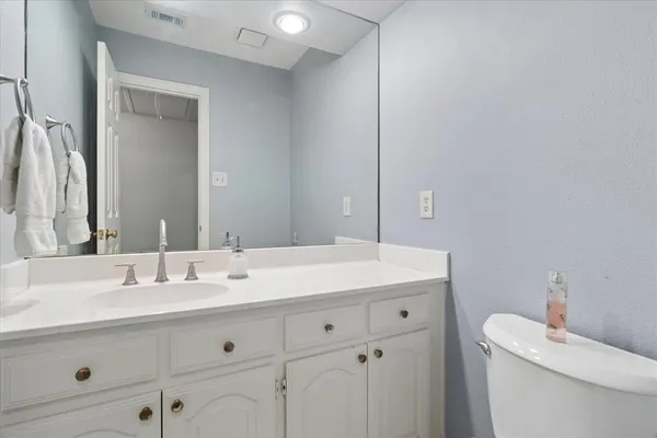 a bathroom with a sink vanity and a mirror