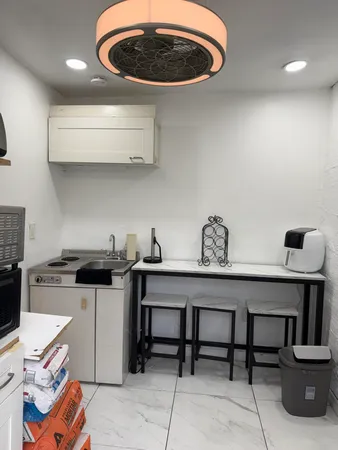 a kitchen with a stove a sink and a dining table