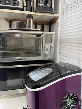 a stove top oven sitting inside of a kitchen