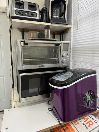 a stove top oven sitting inside of a kitchen