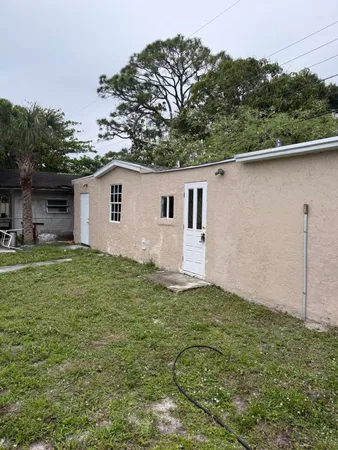 a backyard of a house with table and chairs
