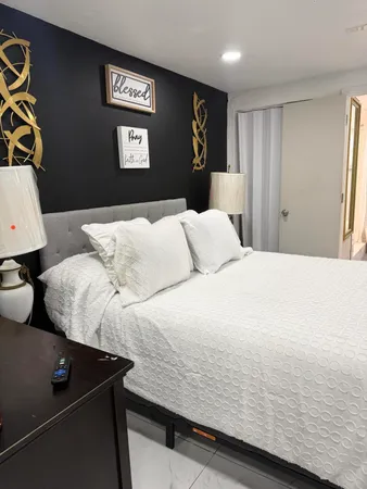 a bedroom with a bed and wall painting