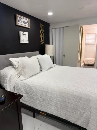 a bedroom with a bed and painting on the wall