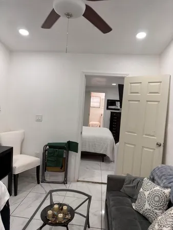 a bedroom with a bed a rug and a chair