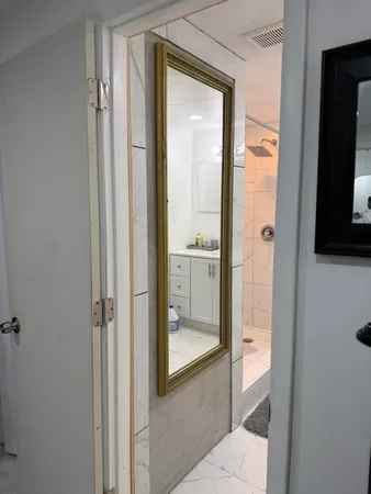 a bathroom with a glass shower door and a mirror