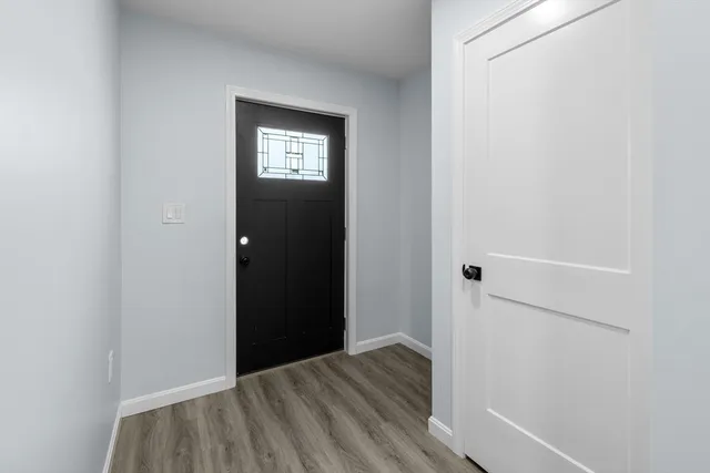 a view of a hallway with wooden floor