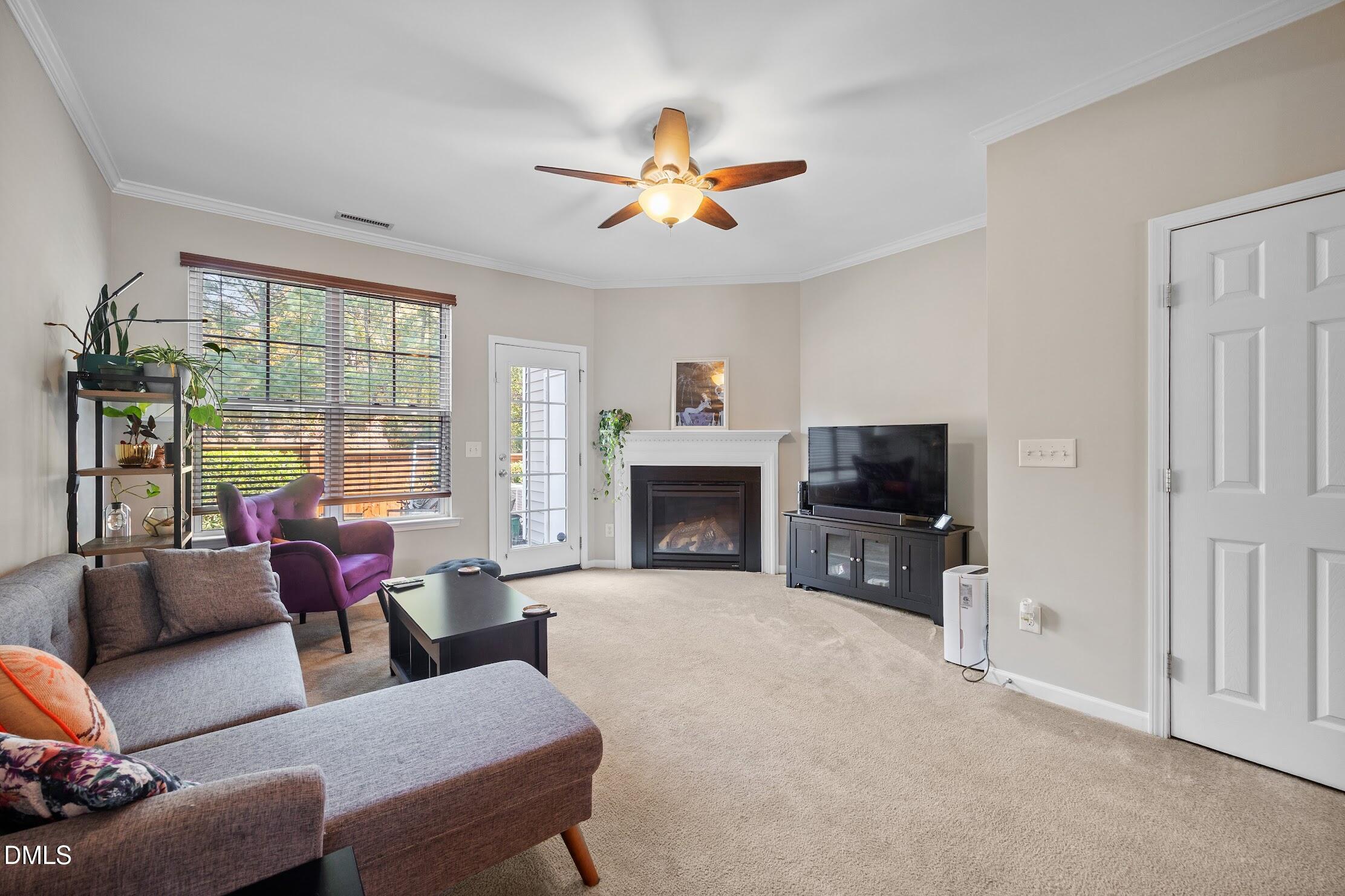 2940 Casona Way Raleigh, NC 27616 - Photo 11 of 23 a living room with furniture a fireplace and a flat screen tv