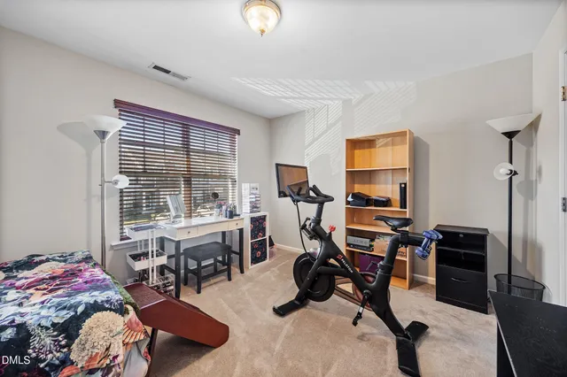 a view of a livingroom with workspace and a window