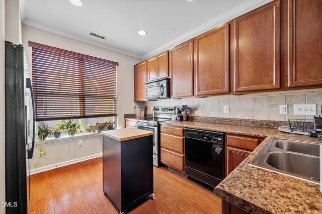 a kitchen with a sink stove top oven and cabinets