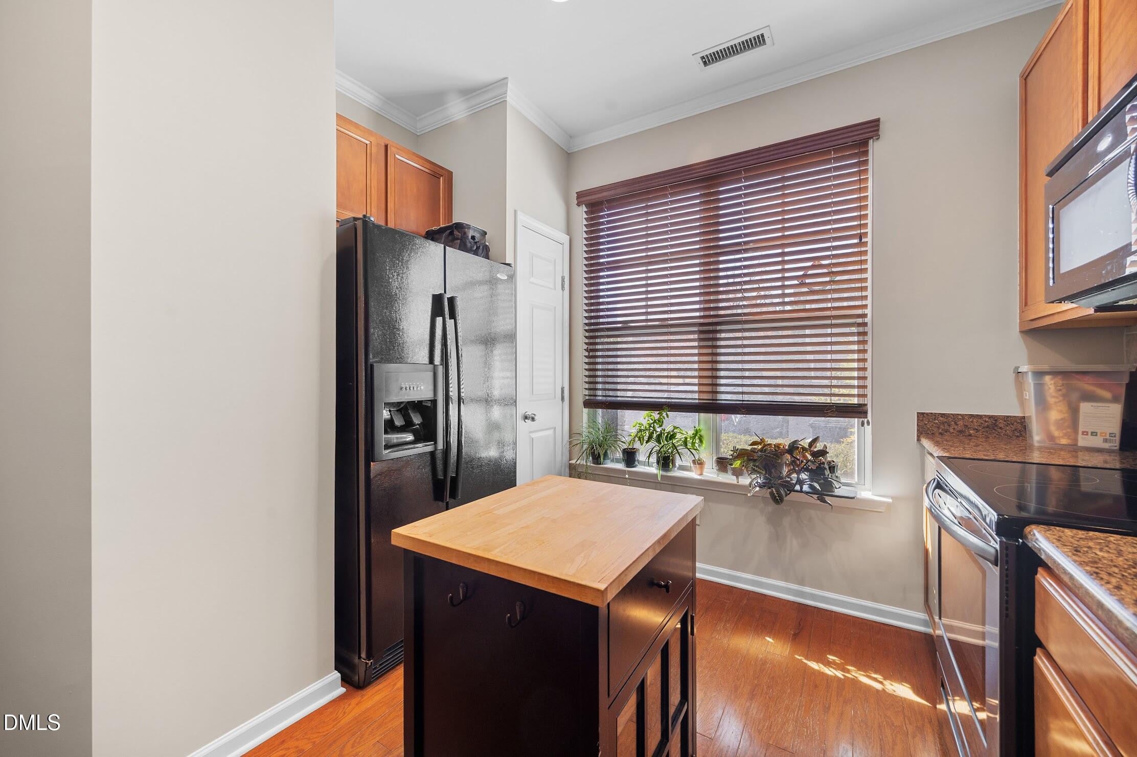 2940 Casona Way Raleigh, NC 27616 - Photo 5 of 23 a kitchen with a refrigerator a sink and a stove
