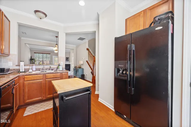 a kitchen with stainless steel appliances granite countertop a refrigerator and a sink