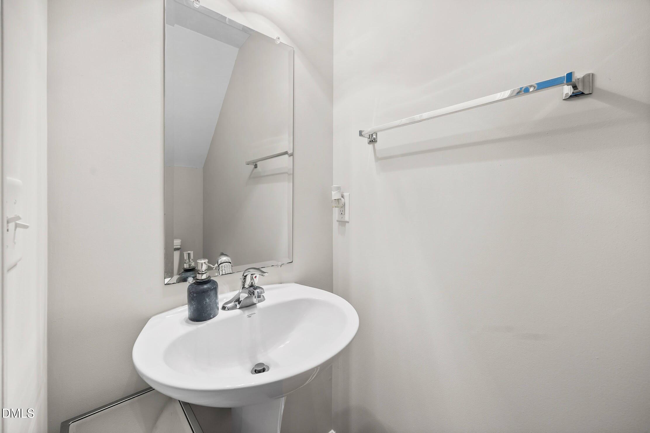 2940 Casona Way Raleigh, NC 27616 - Photo 9 of 23 a bathroom with a sink and a mirror