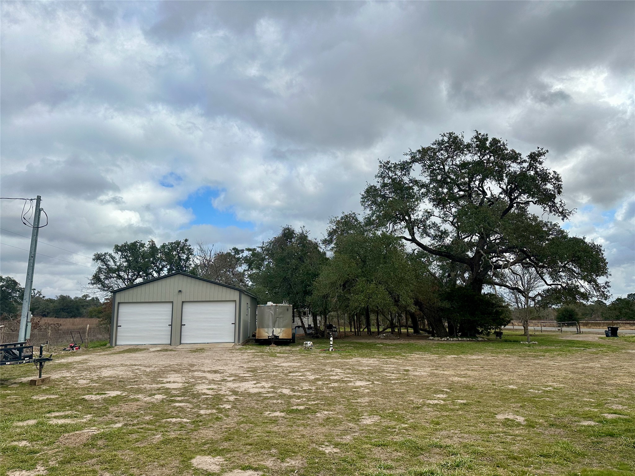 705 Fm 154 Street South Muldoon, TX 78949 - Photo 10 of 18 View of yard with an outbuilding and a detached garage