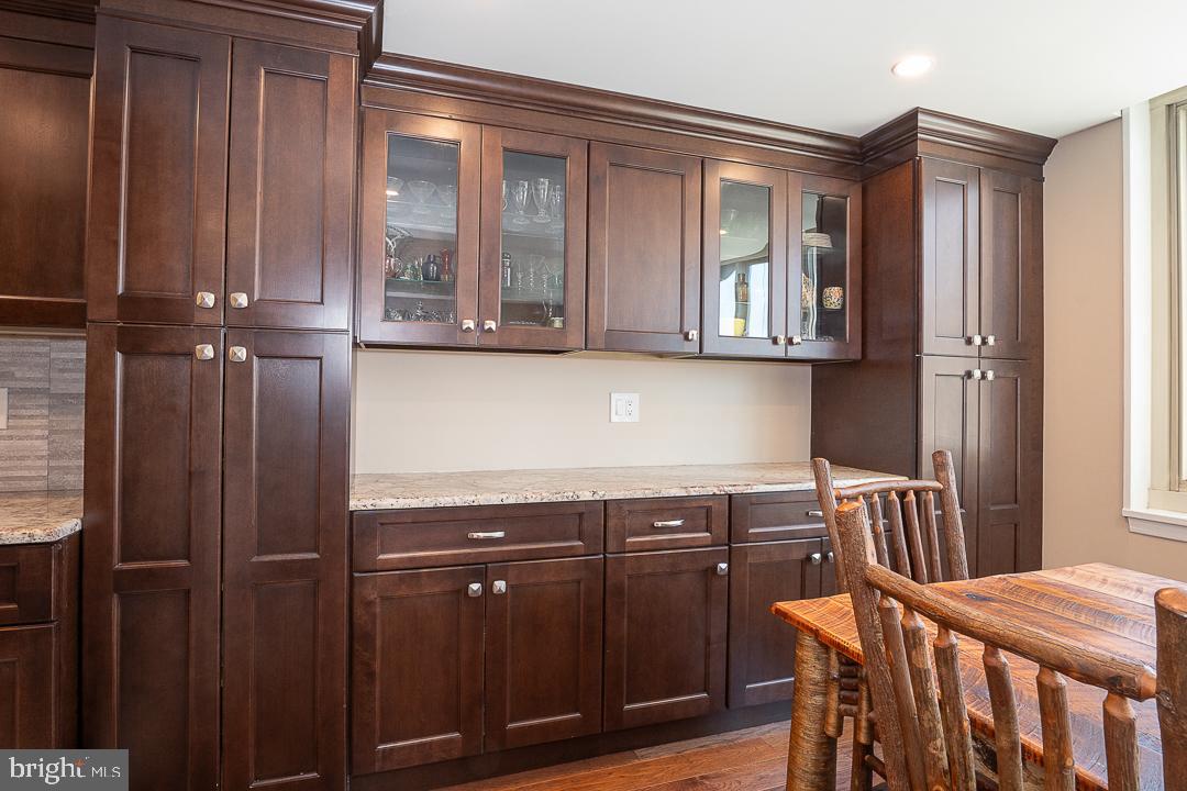 1919 Chestnut Street, Unit 807 Philadelphia, PA 19103 - Photo 4 of 25 a kitchen with a wooden floor and cabinets