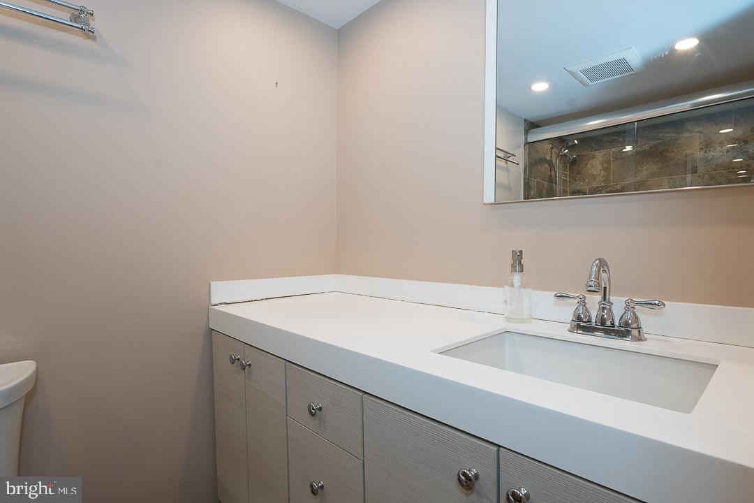 1919 Chestnut Street, Unit 807 Philadelphia, PA 19103 - Photo 10 of 25 a bathroom with a sink and a mirror
