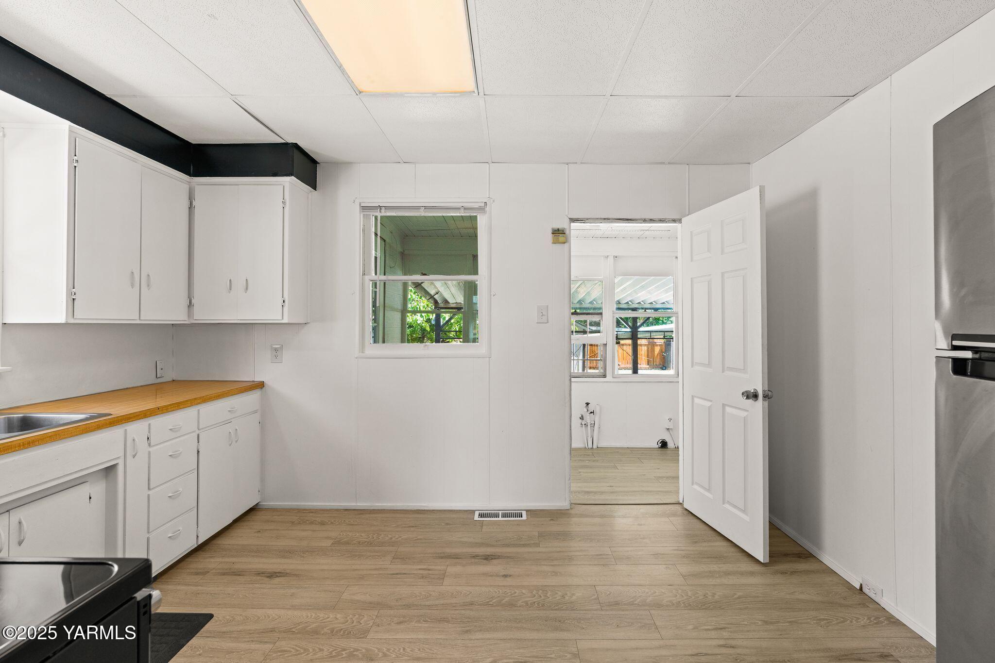 705 South 8th Avenue Yakima, WA 98902 - Photo 13 of 25 a view of a kitchen with wooden floor and electronic appliances