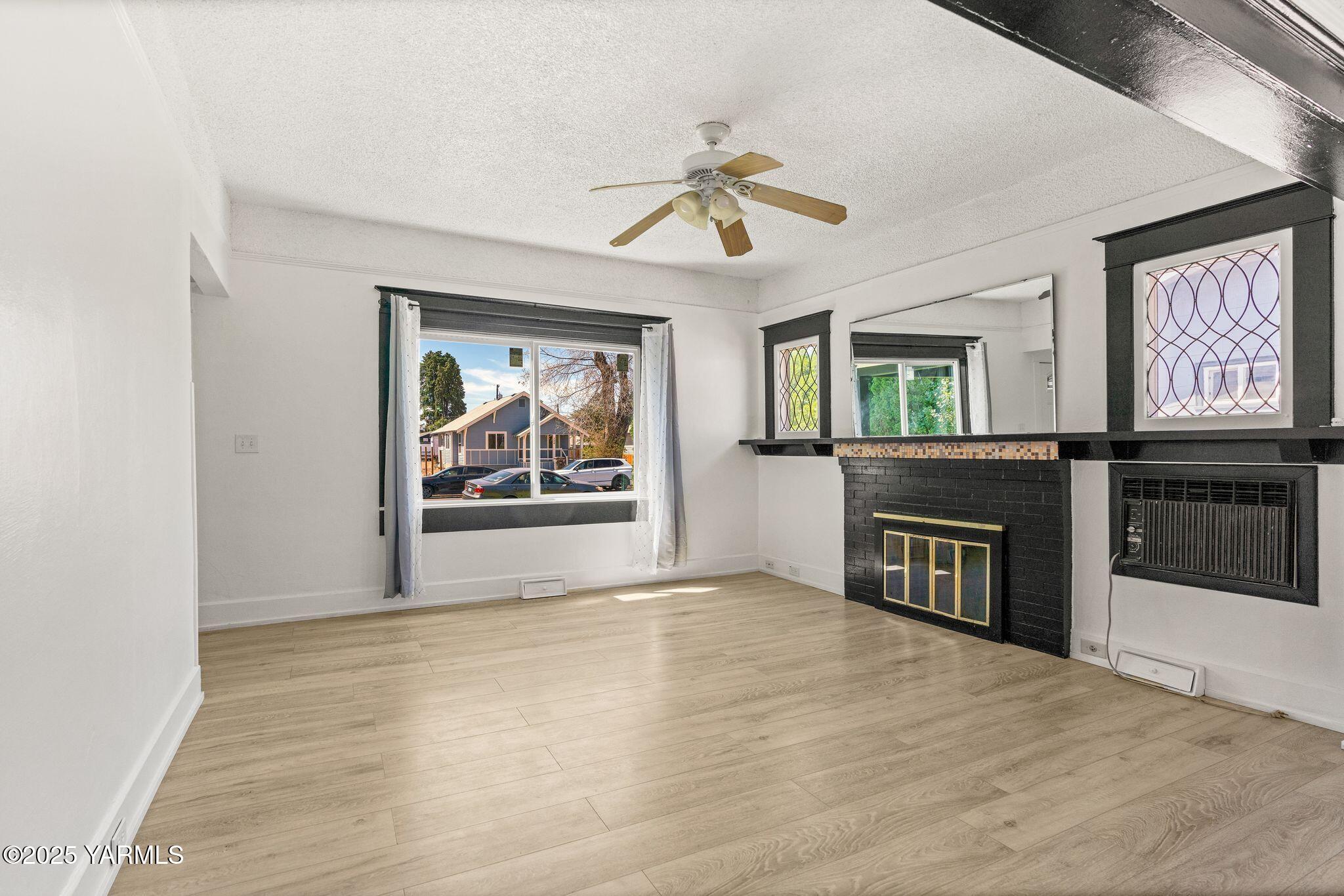 705 South 8th Avenue Yakima, WA 98902 - Photo 5 of 25 a view of an empty room with a window and fireplace
