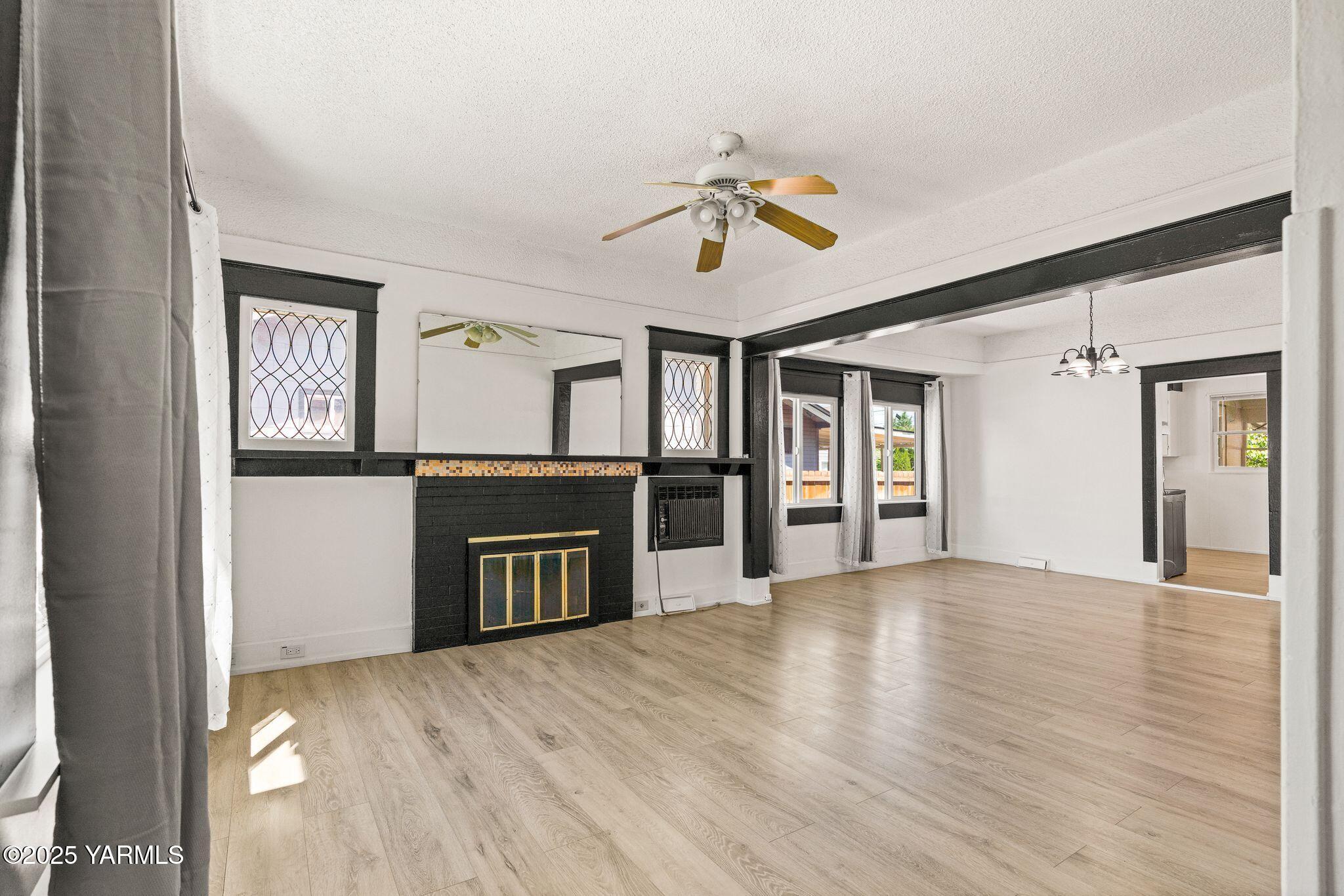 705 South 8th Avenue Yakima, WA 98902 - Photo 6 of 25 a view of an empty room with window and wooden floor