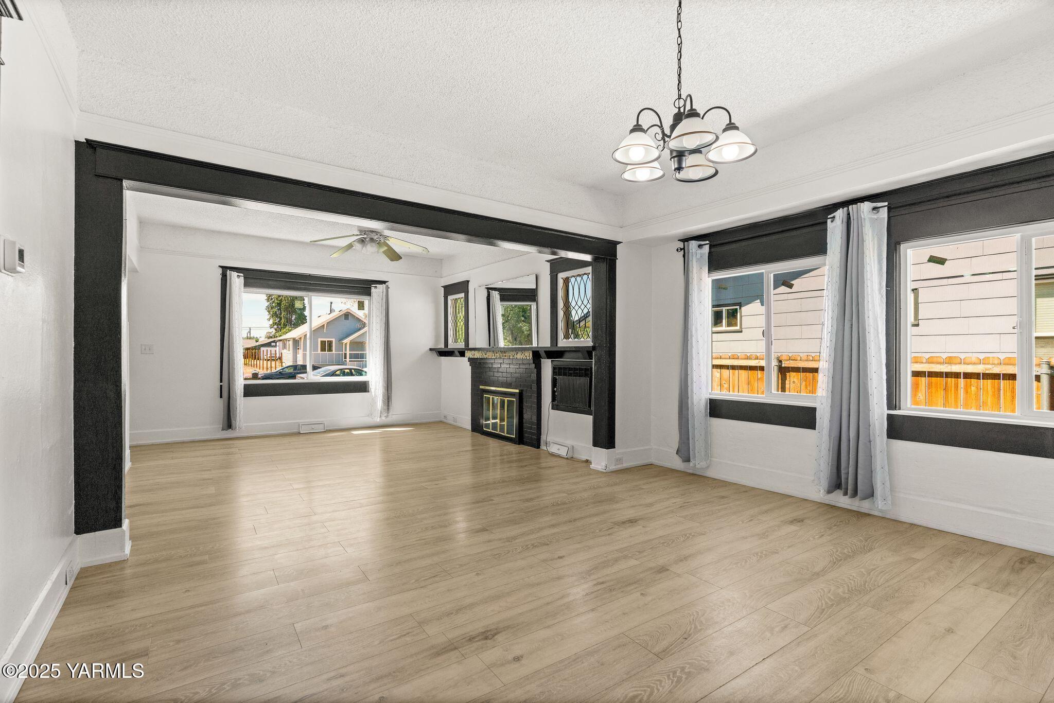 705 South 8th Avenue Yakima, WA 98902 - Photo 9 of 25 a view of an empty room with window and wooden floor