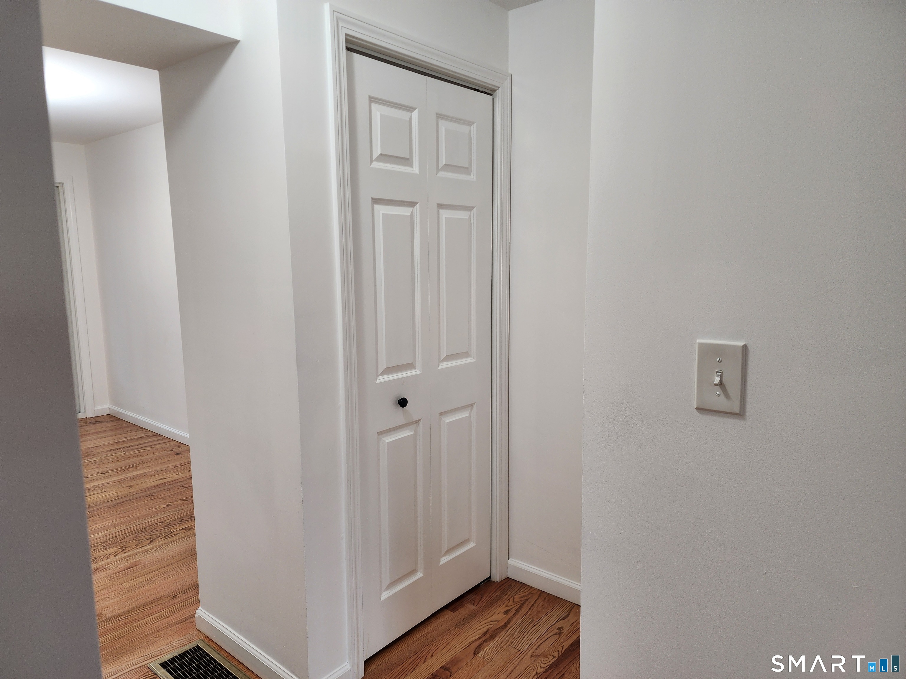 71 Towne House Road, Unit 71 Hamden, CT 06514 - Photo 15 of 32 a view of a hallway with wooden floor