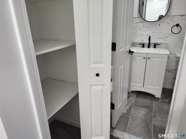 a bathroom with a sink mirror and toilet
