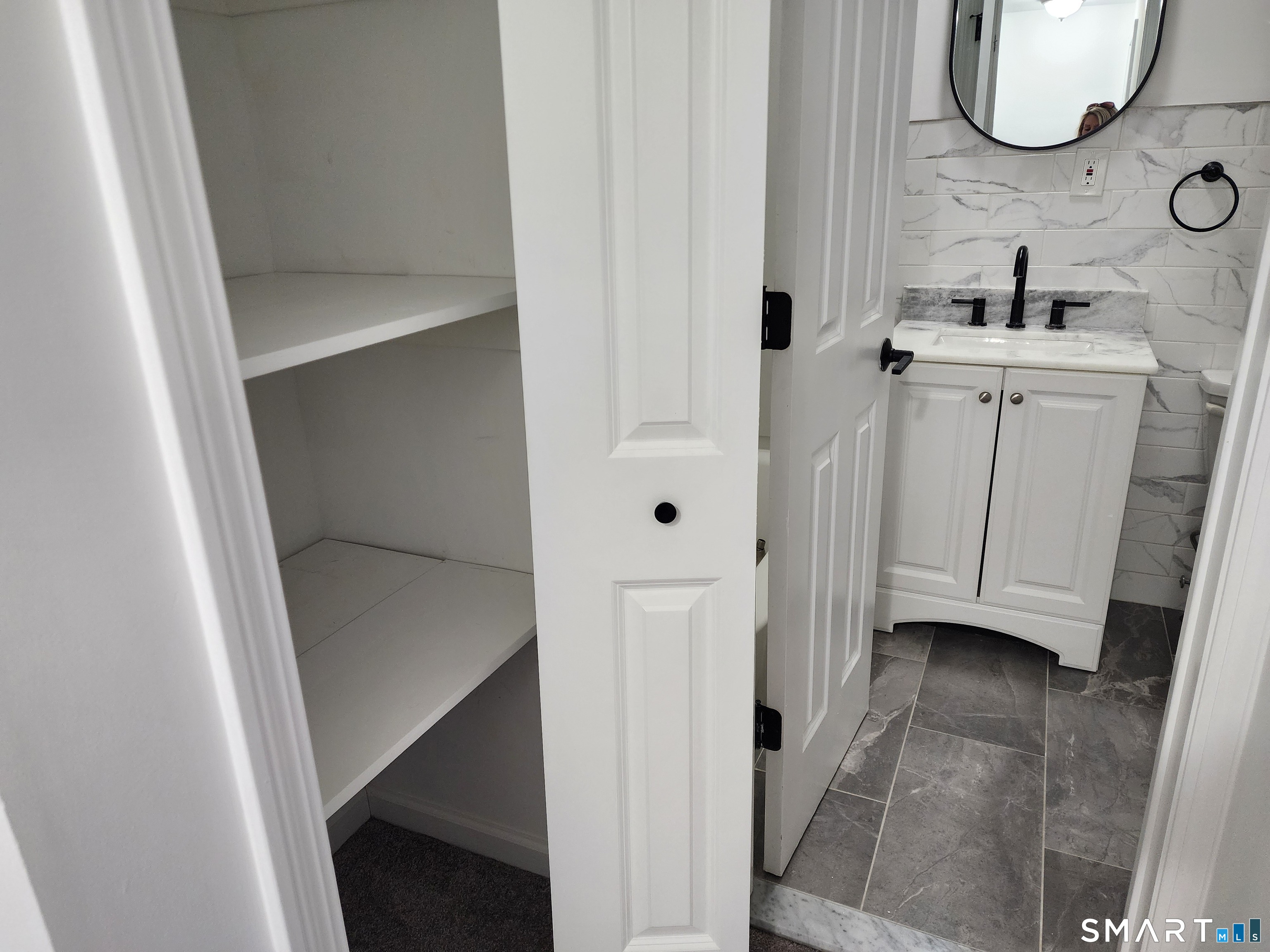 71 Towne House Road, Unit 71 Hamden, CT 06514 - Photo 16 of 32 a bathroom with a sink and a mirror