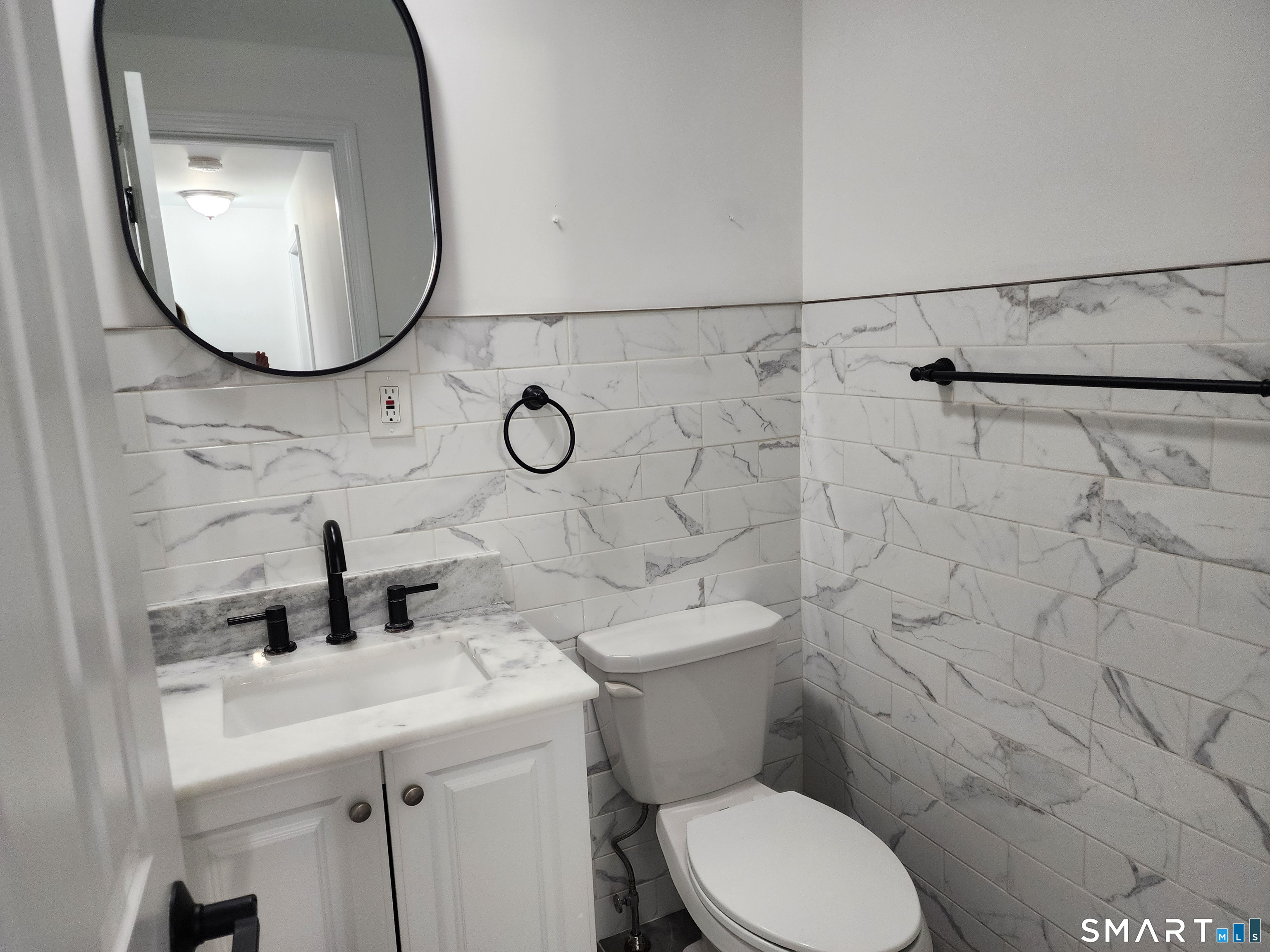 71 Towne House Road, Unit 71 Hamden, CT 06514 - Photo 17 of 32 a bathroom with a sink mirror and toilet