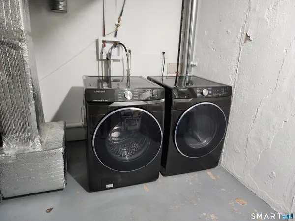 a view of a kitchen with fridge and workspace