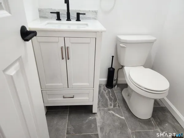 a view of walk in closet with wooden floor washer and dryer