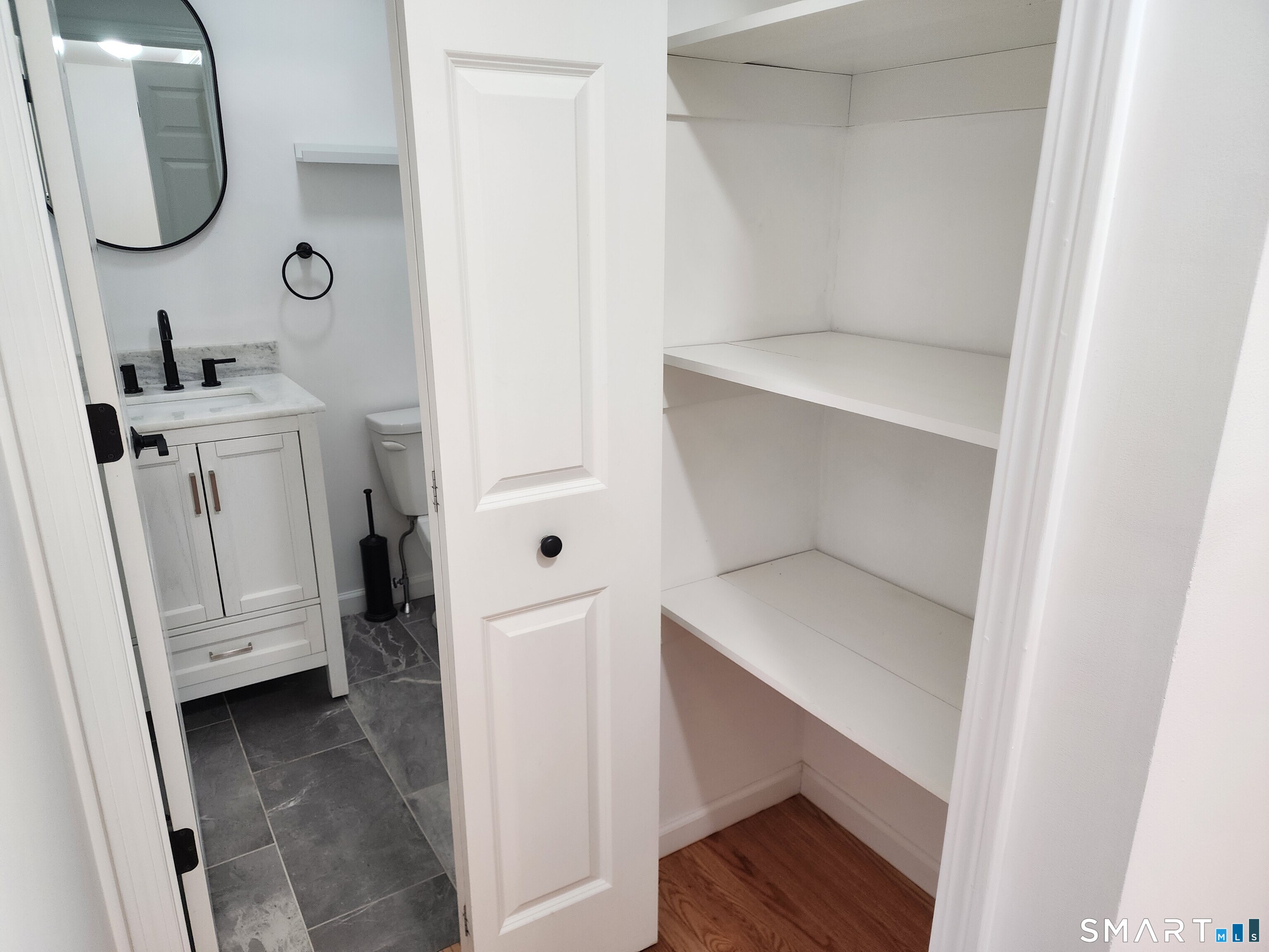 71 Towne House Road, Unit 71 Hamden, CT 06514 - Photo 7 of 32 a view of walk in closet with wooden floor washer and dryer