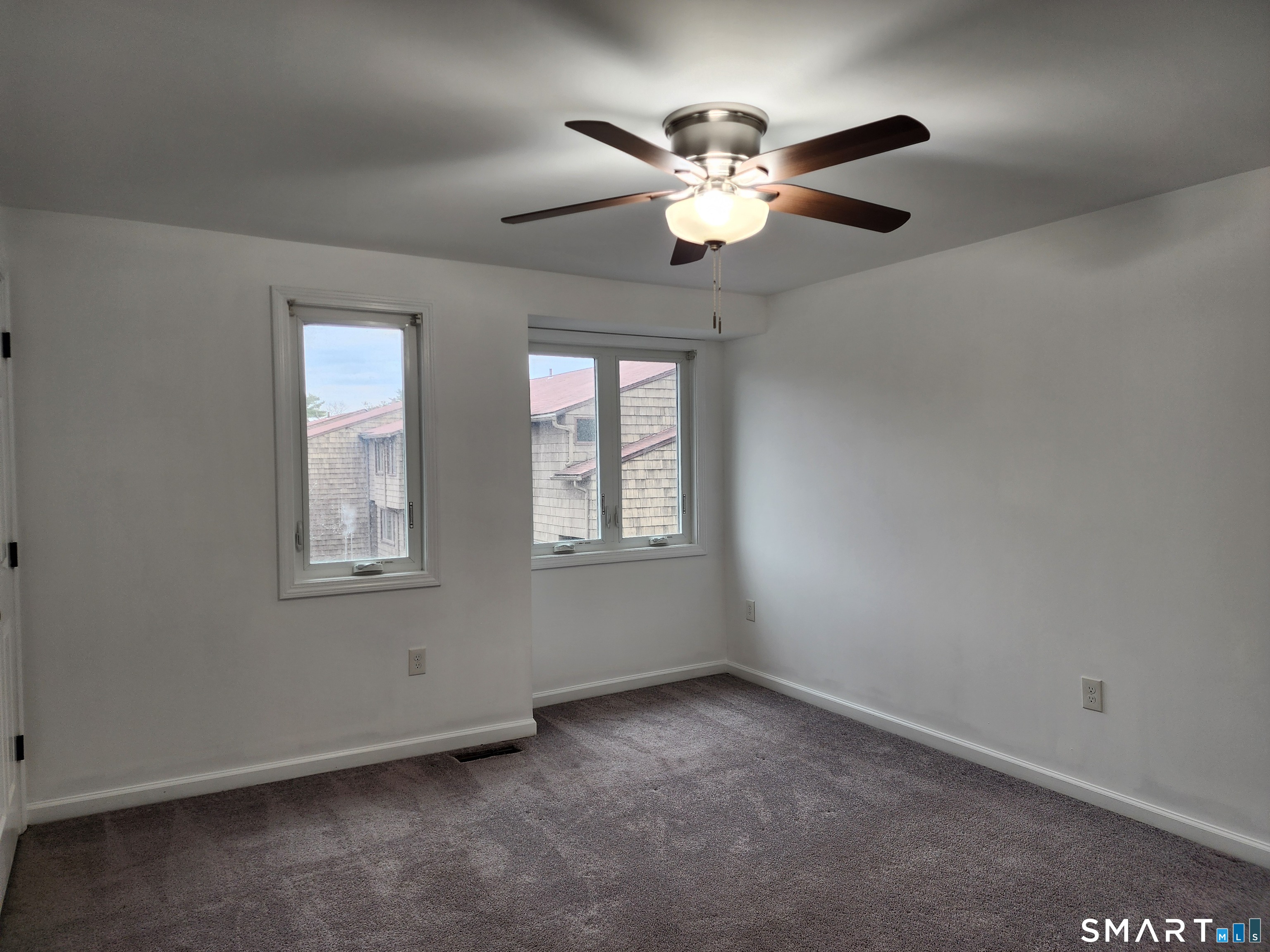 71 Towne House Road, Unit 71 Hamden, CT 06514 - Photo 8 of 32 an empty room with windows and fan