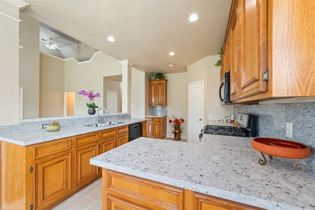 a kitchen with stainless steel appliances granite countertop a sink and cabinets
