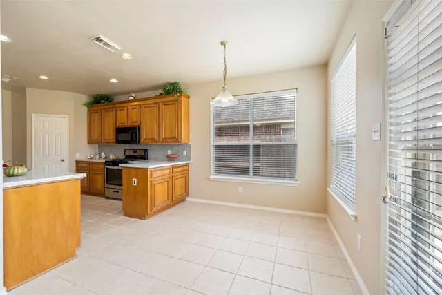 a kitchen with window and cabinets