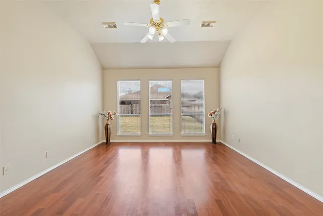 wooden floor in an empty room with a window