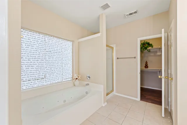 a bathroom with a bathtub and a shower