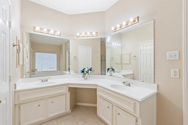 a bathroom with a sink double vanity and a mirror