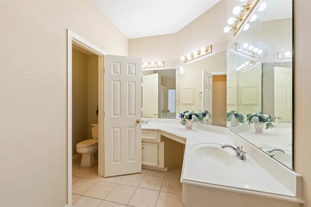 a large bathroom with a double vanity sink a mirror and a bathtub
