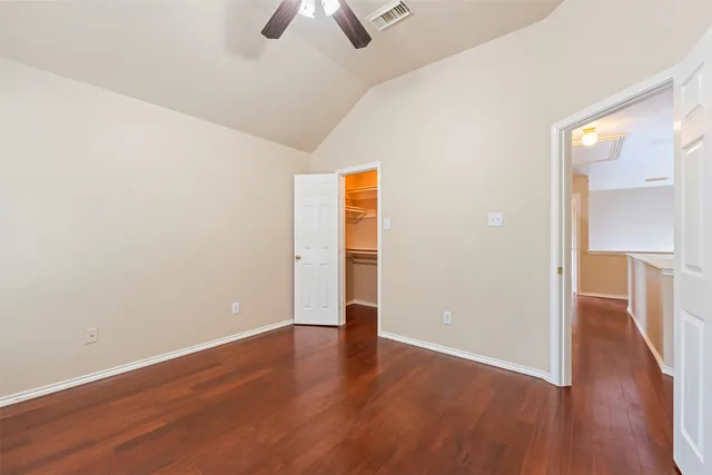 an empty room with wooden floor and closet