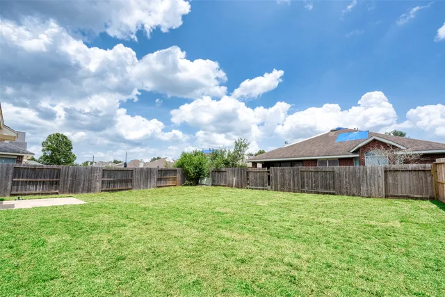 a view of a house with a yard and sitting area
