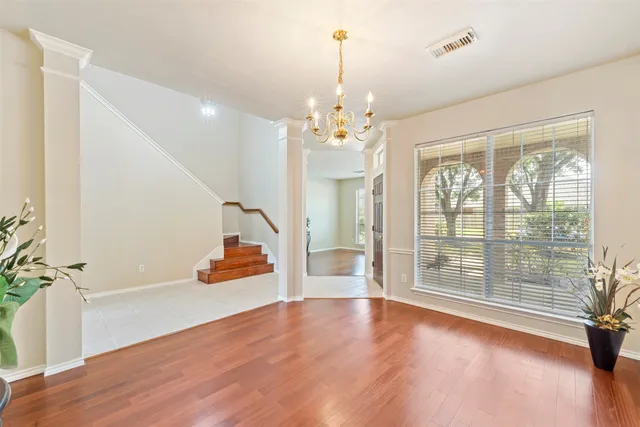 a view of a room with wooden floor and windows