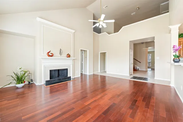 a view of a livingroom with wooden floor and a fireplace