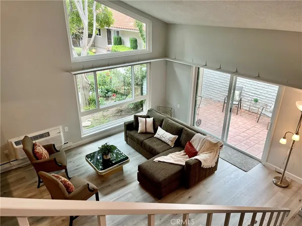 a living room with furniture and a floor to ceiling window
