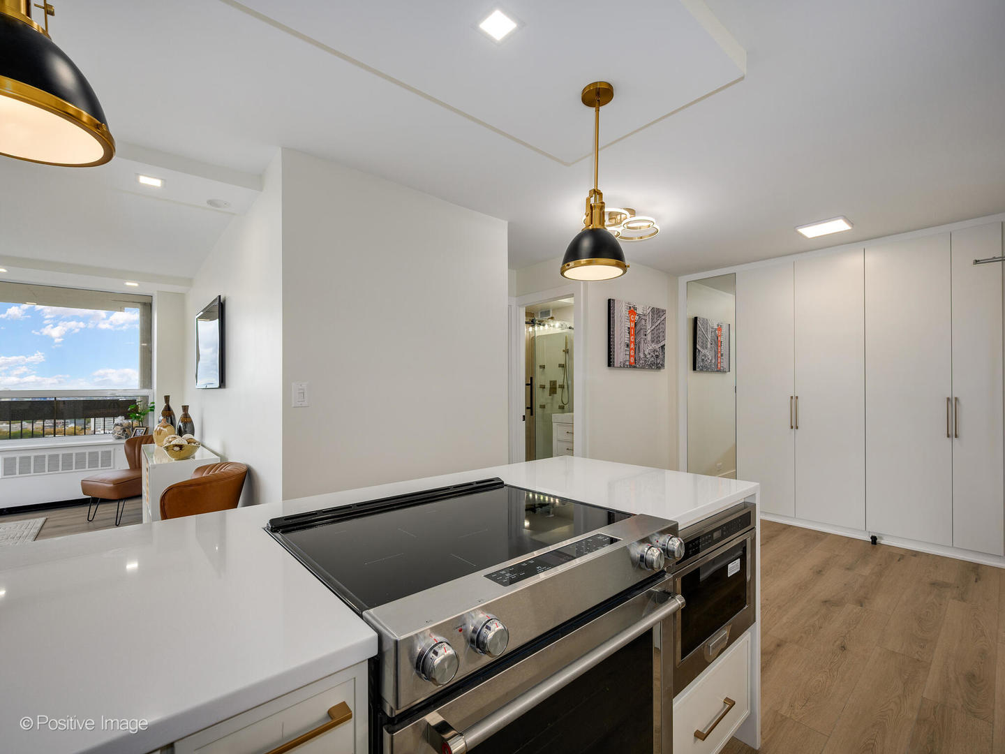 1355 North Sandburg Terrace, Unit 2201D Chicago, IL 60610 - Photo 15 of 44 a kitchen with a stove and a chandelier