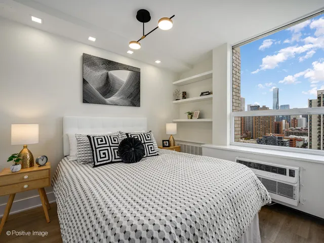 a bedroom with a large bed and a large window