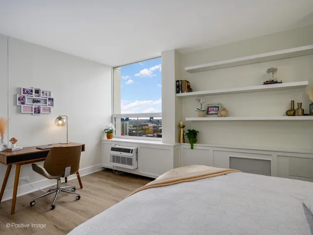 a bedroom with a workspace