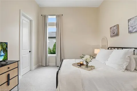 a bedroom with a bed and a mirror