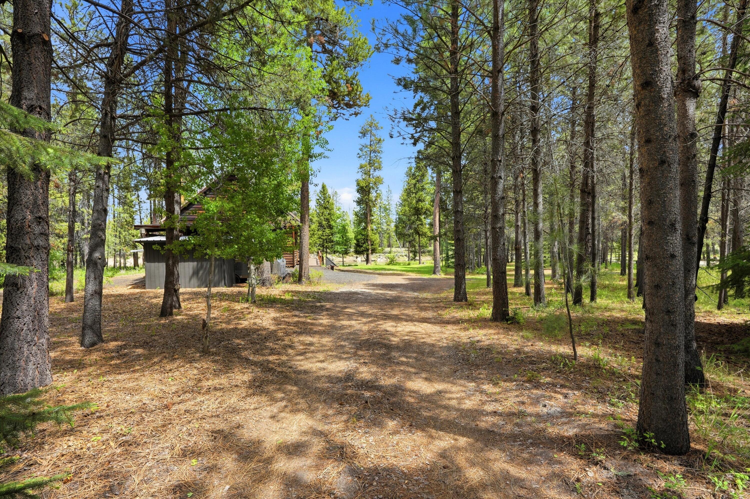 56446 Eclipse Drive Bend, OR 97707 - Photo 8 of 42 a backyard of a house with lots of green space
