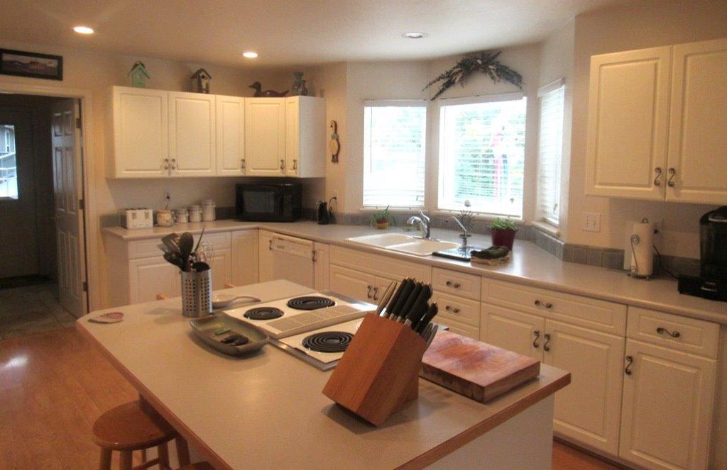 1961 Crow Road Merlin, OR 97532 - Photo 11 of 35 a kitchen with a sink a stove and a refrigerator